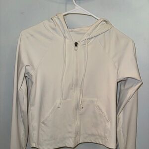 cream colored cropped fabletics zip up